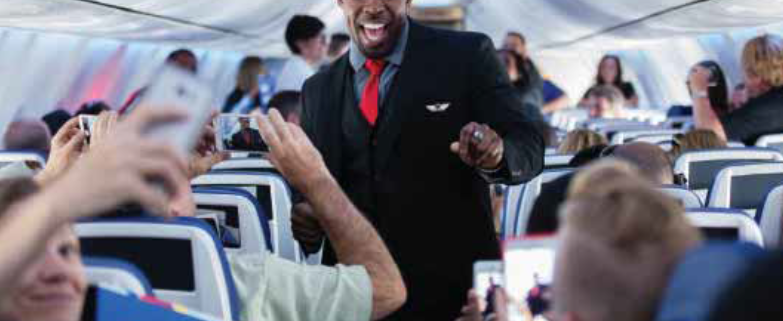 Flight Attendant walks through plane.